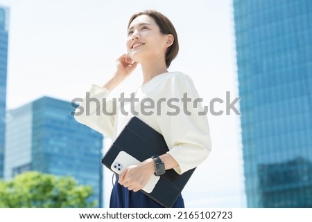 Woman looking up at the sky (business woman) Royalty-Free Stock Photo #2165102723