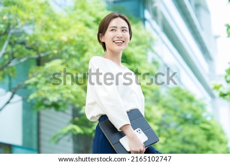 Woman looking up at the sky (business woman) Royalty-Free Stock Photo #2165102747