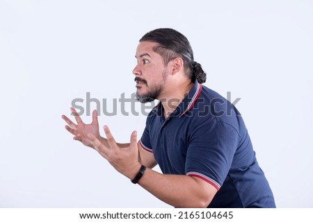 Side view of a bearded man in his 30s procrastinating or complaining. Isolated on a white background. Royalty-Free Stock Photo #2165104645