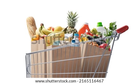 Shopping cart full of fresh groceries, grocery shopping concept Isolated on white background Royalty-Free Stock Photo #2165116467