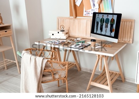 Workplace of clothes stylist in modern studio