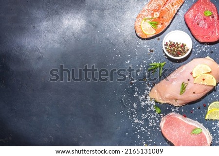 Various natural food, high animal protein sources - pork, beef meat steaks, chicken breast fillet, eggs, salmon fish on white table background top view copy space 