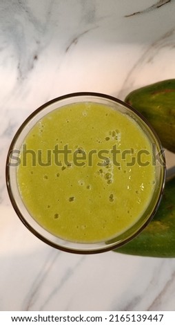 Avocado juice that is both fresh and healthful, with a flat lay angle. 