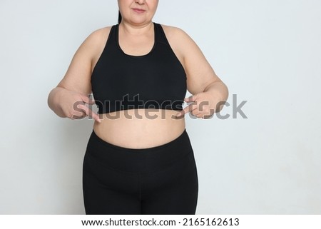 Obese woman on white background, closeup with space for text. Weight loss surgery Royalty-Free Stock Photo #2165162613