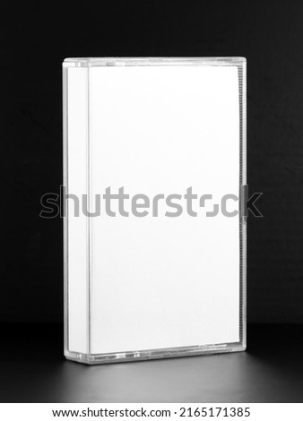 Blank compact cassette tape box design mockup view. Vintage cassete tape record case box mock up. Plastic analog magnetic tape cassette clear packaging template. Mixtape box cover	 Royalty-Free Stock Photo #2165171385
