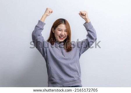 Portrait of beautiful Asian woman doing cheerful pose on isolated background, portrait concept used for advertisement and signage, isolated over white background, copy space.