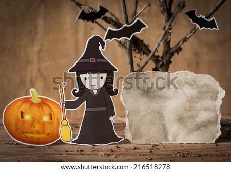 Little witch with halloween pumpkin and blank paper.