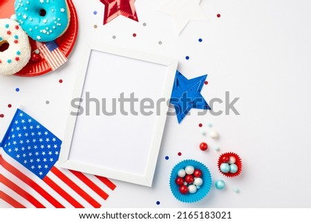 USA Independence Day concept. Top view photo of national flag photo frame stars confetti paper baking molds with sweets and plate with glazed donuts on isolated white background with copyspace