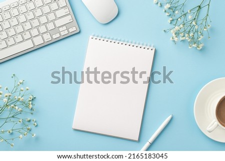 Business concept. Top view photo of workspace keyboard computer mouse open reminder pen cup of coffee on saucer and white gypsophila flowers on isolated pastel blue background with empty space
