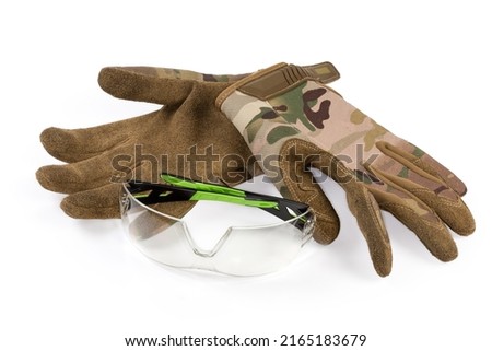 Ballistic protective eyewear and pair of the tactical military gloves made with textile and leathern on a white background
 Royalty-Free Stock Photo #2165183679
