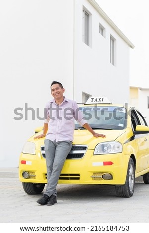 Portrait of Ecuadorian taxi driver. Yellow taxi in Ecuador. Copy space. Royalty-Free Stock Photo #2165184753