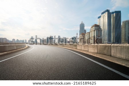 Low angle curvy flyover highway moving forward road with kuala lumpur cityscape evening scene view. Royalty-Free Stock Photo #2165189625