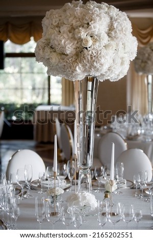 Bouquet of flowers in vase on the wedding table.