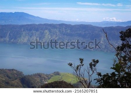 the beautiful view from the top of the mountain, with the blue sky and the lake is so amazing