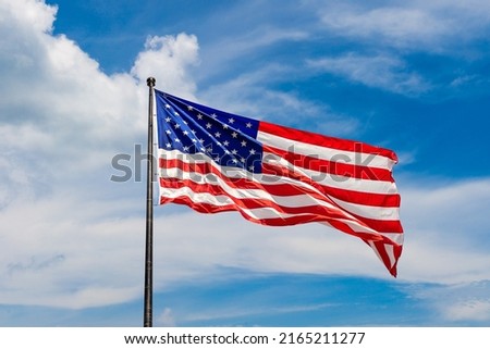 USA flag waving against sky with beautiful cloud