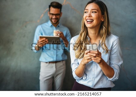 Diverse business people colleagues laughing having fun with digital gadgets in office. Royalty-Free Stock Photo #2165214057