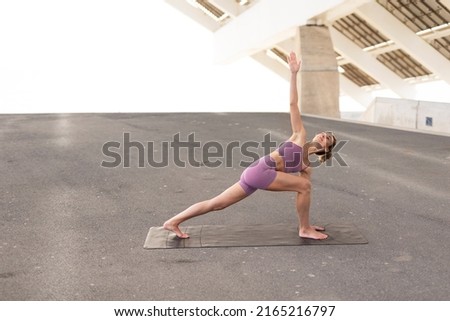 Young woman doing stretching exercise after running outside. Healthy lifestyle	