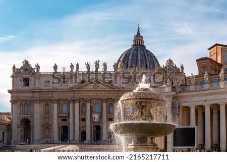 Scenic view on Fontaine di Piazza San Pietro fountain on St Peter square and Saint Peter Basilica in the Vatican City, Rome, Lazio, Europe, EU. Church Papale di San Pietro in Vaticano during daytime Royalty-Free Stock Photo #2165217711
