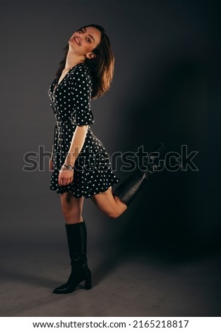 Fashion woman portrait.young model wearing black evening dress.Studio isolated,dark  background.Fashion model studio posing