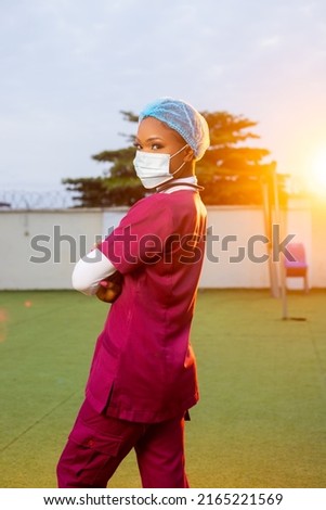 Young black female healthcare worker smiling outside, portrait