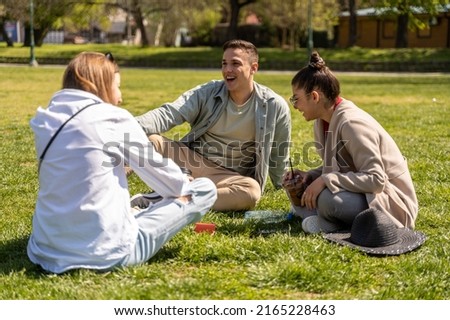 Stylish group of people enjoying in beautiful summer time while listening music on portable bluetooth speaker Royalty-Free Stock Photo #2165228463