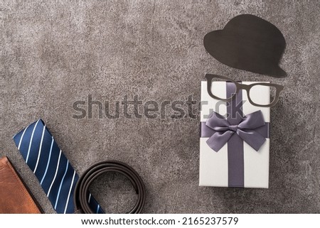 Father's day background design concept. Top view of paper decoration ideas with gift box on gray table background.