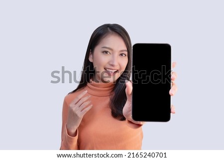 Asian Woman Show Big Mobile Phone Screen with Blank Copy Space Royalty-Free Stock Photo #2165240701