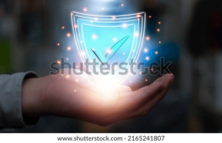 Shield protection on businessman hand in privacy technology concept