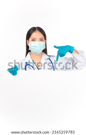 portrait asian female doctor with stethoscope in uniform protection facial mask wearing surgical gloves showing presenting finger to paper billboard, doctor healthcare and doctors concept. 