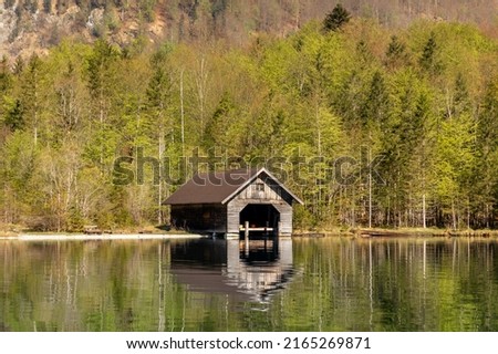Lonely boathouse at lake Koenigssee in Bavaria, Germany Royalty-Free Stock Photo #2165269871