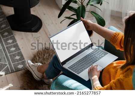 Young woman using laptop to work at home, remote work Royalty-Free Stock Photo #2165277857