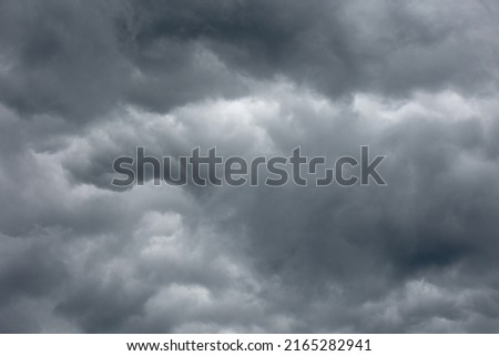Dense storm clouds with a blue tint