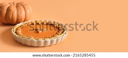 American Pumpkin Pie for autumn holiday on orange background with copy space. Close up. Happy Thanksgiving Day. Banner. Royalty-Free Stock Photo #2165285455