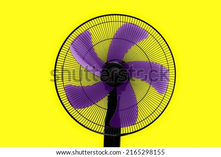black fan with purple blades and yellow background