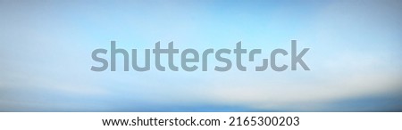 Cloudscape. Clear blue glowing sky. Soft sunlight. Panoramic image, texture, background, graphic resources, design, copy space. Meteorology, heaven, hope, peace concept