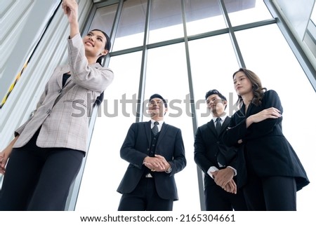 A group of Asian businessmen are gathering ideas to share ideas and offer ideas at a board in the office. with determination, determination and good fun