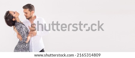 Banner dance concept - Active happy adults dancing bachata or salsa kizomba together over white background with copy space Royalty-Free Stock Photo #2165314809