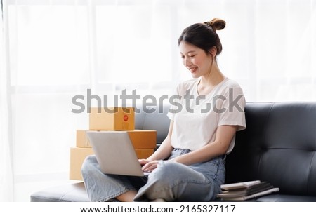 Business digital online SME small business a new startup in the present for an online shop. Happy Young Asian woman have a warehouse used to send a customer Entrepreneur owner SME or freelance concept Royalty-Free Stock Photo #2165327117