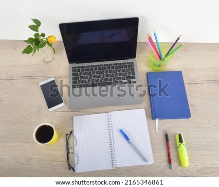 Top view office table desk. Workspace with blank, office supplies, laptop, eyes glasses, rose flower on wood background, office table desk with rose flower,office table desk with laptop, phone.