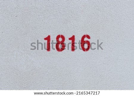 Red Number 1816 on the white wall. Spray paint.
