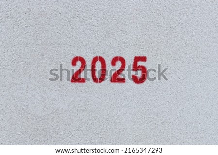 Red Number 2025 on the white wall. Spray paint.
