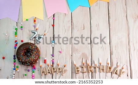 Birthday with number 74. Donut on the festive table. Happy birthday congratulations top view. Happy birthday card with beautiful decorations on a white board table.