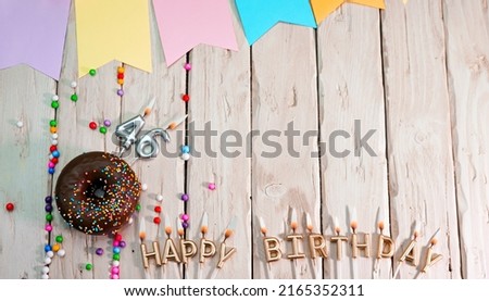 Birthday with number 46. Donut on the festive table. Happy birthday congratulations top view. Happy birthday card with beautiful decorations on a white board table.
