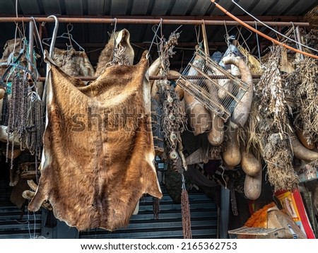 Animal pelts, gourds and beads for sale in the Marrakech medina. Royalty-Free Stock Photo #2165362753