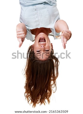 Upside down thumb's up. Cropped shot of an attractive young woman isolated on white. Royalty-Free Stock Photo #2165363509