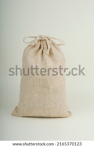 white small gunny sack with lace Royalty-Free Stock Photo #2165370123