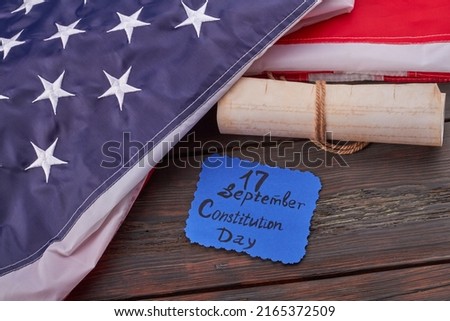 September seventeenth constitution day concept. Top view flat lay. Old scroll with United States constitution preamble with handwritten we the people.