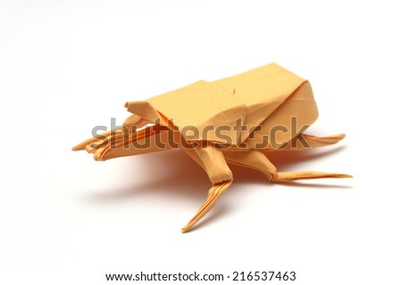 Orange paper origami bug isolated on white