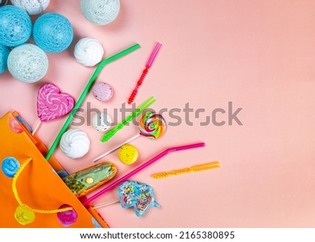 bright gift bag, cocktail straws, sweets, marshmallows, ribbons, hearts, stars and festive garland