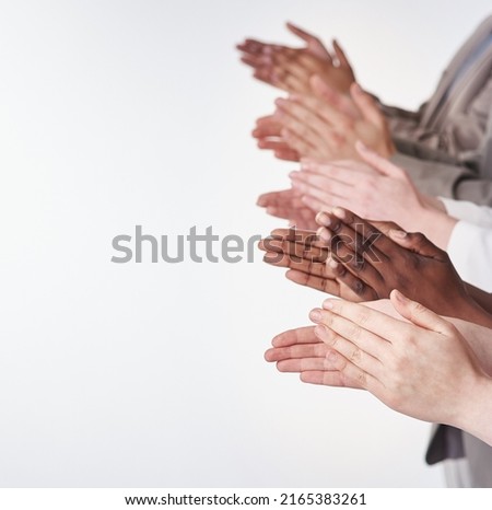 Rounds of applause. Shot of a group of people clapping their hands together. Royalty-Free Stock Photo #2165383261